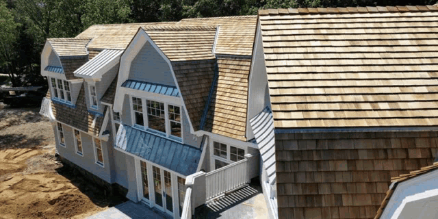 a large house with a wooden roof and a metal roof