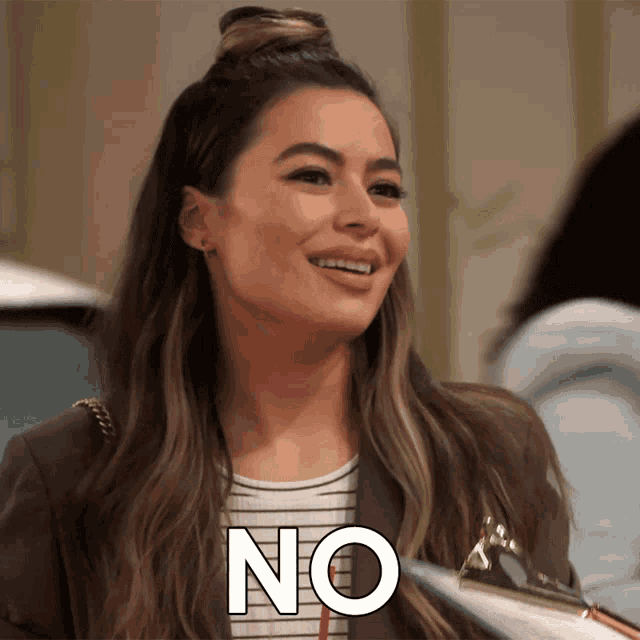 a woman is smiling and holding a clipboard with the word no written on it