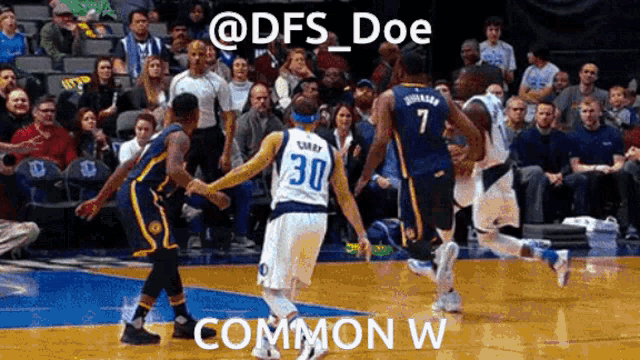 a basketball player with the number 30 on his jersey dribbles the ball