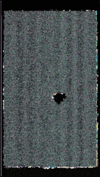 a black hole in the middle of a gray and green carpet