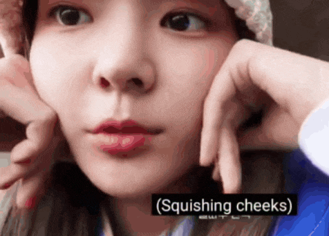 a close up of a woman 's face with squishing cheeks
