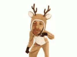 a man is wearing a reindeer costume and dancing .