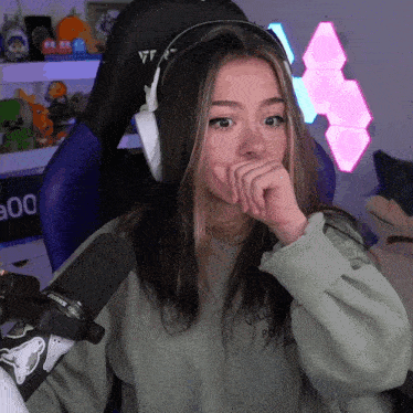 a girl wearing headphones and a sweatshirt that says " villain "