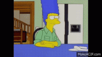 a cartoon of marge simpson sitting at a table with makeagif.com in the corner