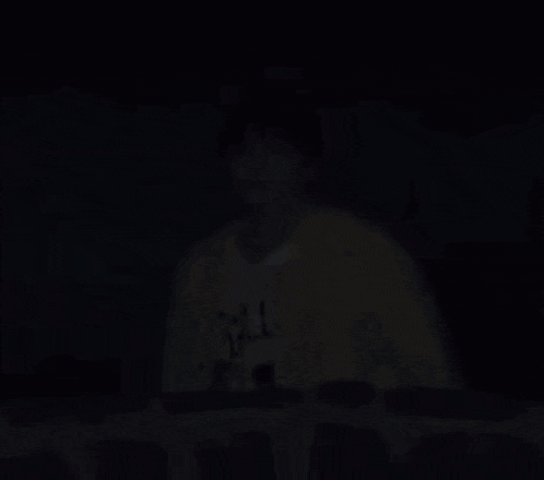 a man wearing a yellow cardigan and a white shirt with the word art on it