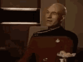 a man in a red uniform is clapping his hands .