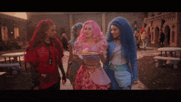 a girl with pink hair is holding a tray of cupcakes