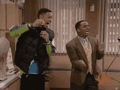 two men are standing next to each other in a kitchen and dancing .