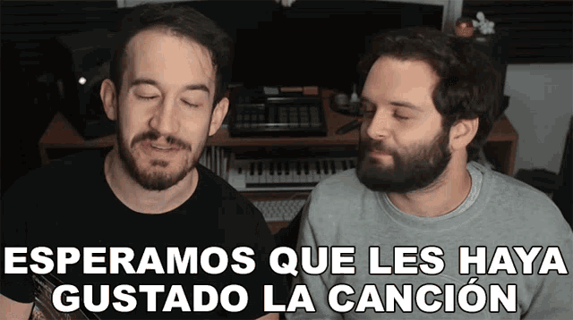 two men singing in front of a keyboard with the words " esperamos que les haya gustado la cancion " above them