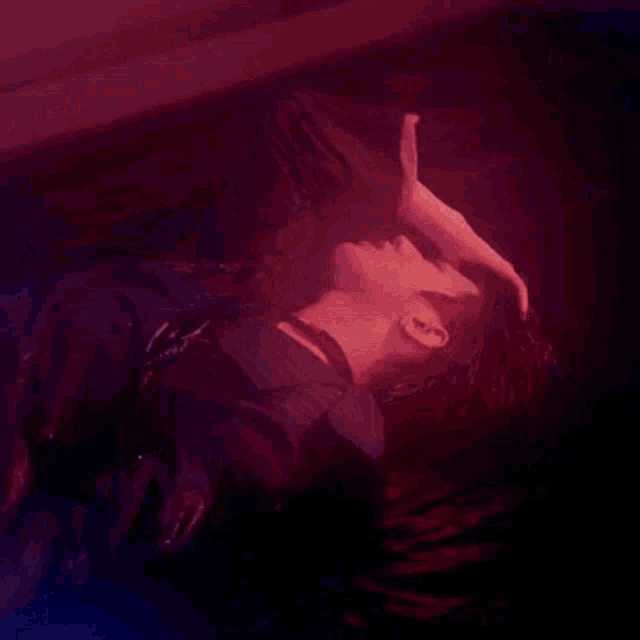 a man is laying on his back with his head in the air