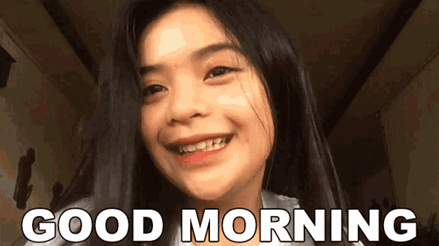 a girl is smiling and the words good morning are behind her