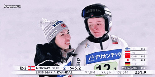 a woman wearing a helmet that says uvex is hugging another woman