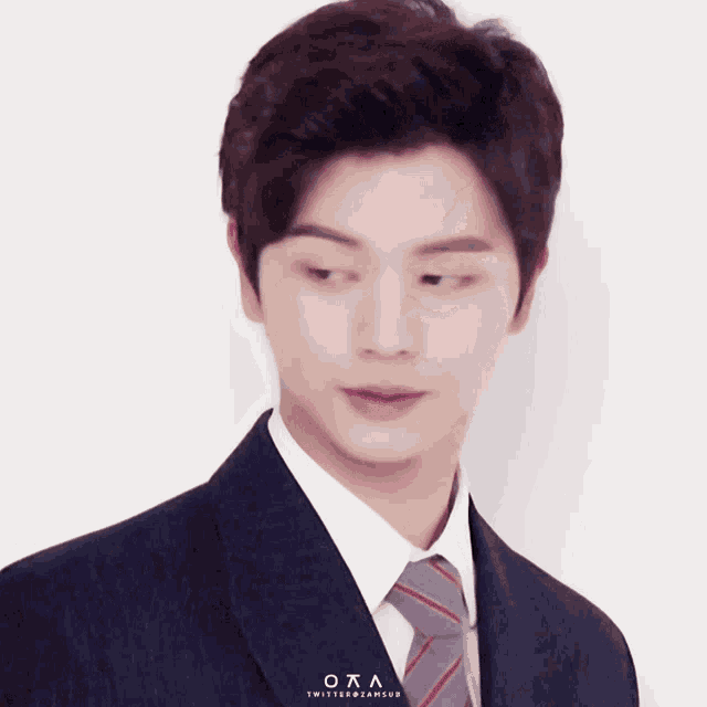 a man wearing a suit and tie with the letters oaa on the bottom
