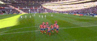a group of soccer players standing on a field wearing jerseys with the numbers 1 through 9