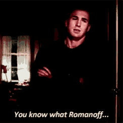a man is standing in a dark room and says " you know what romanoff ... "