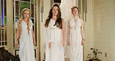 three women are standing next to each other in white dresses .