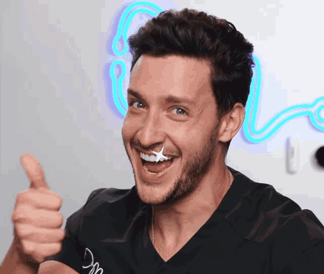 a man giving a thumbs up with a star on his face