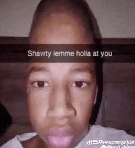 a close up of a person 's face with a caption that says `` shawty lemme holla at you '' .