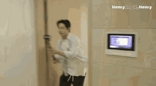 a man in a white shirt is running in a room with zoom written on the bottom
