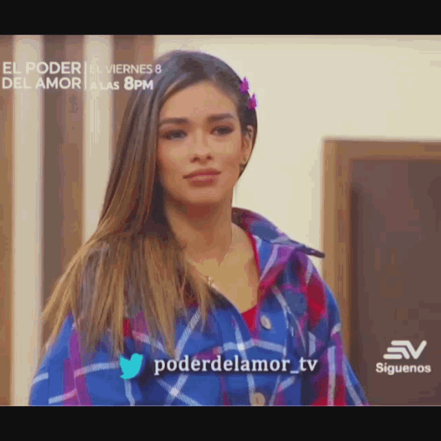 a woman in a plaid shirt is standing in front of a sign that says el poder del amor a las 8 pm