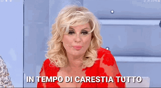 a woman in a red dress with the words in tempo di carestia tutto