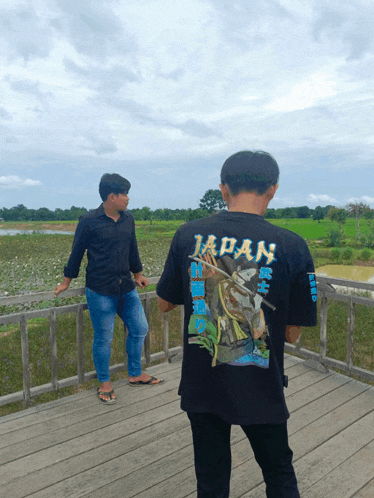 a man wearing a black shirt that says japan on the back