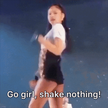 a woman is dancing on a stage with the words `` go girl , shake nothing '' written on the bottom .
