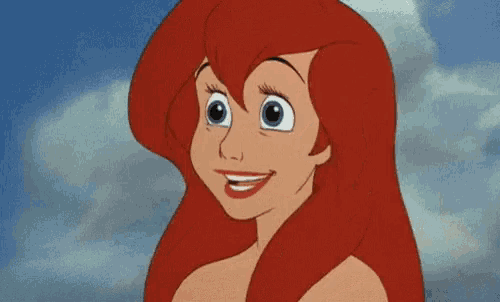 a close up of a cartoon character with red hair and a big smile on her face .