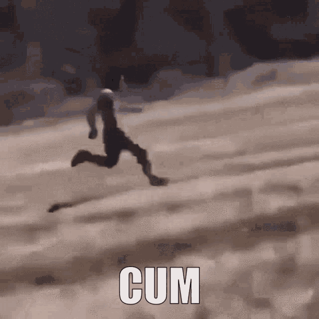 a man is running down a snowy hill with the word cum in the foreground