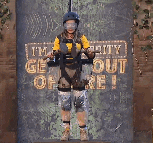 a woman stands in front of a sign that says ' i 'm dirty get out of here '