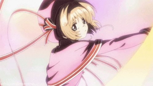 a girl in a pink cape with ribbons around her neck