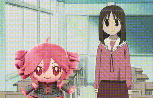 two anime girls are standing in a classroom next to a stuffed toy .