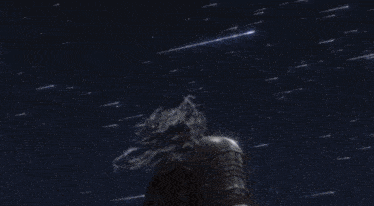 a blue light is shining through a cloudy night sky
