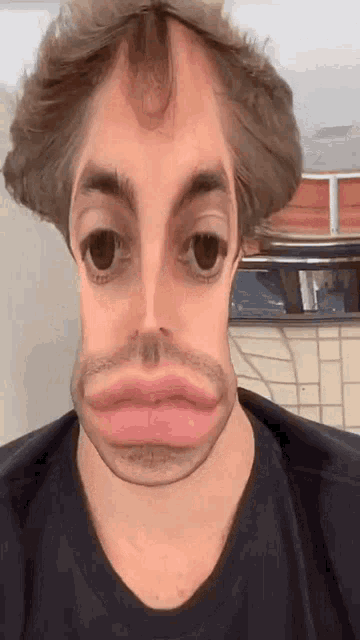 a man wearing a black shirt has a very big face