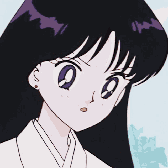 a girl with purple eyes is holding a small object in her hand