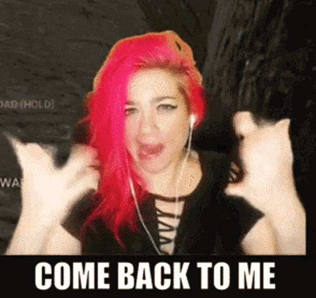 a woman with pink hair is giving a thumbs up with the words come back to me behind her