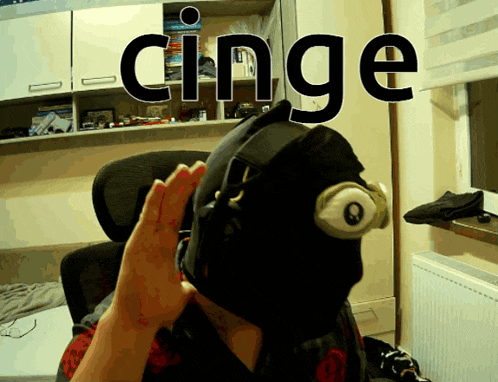 a person wearing a black mask with the word cinge above it