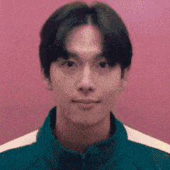 a pixelated image of a young man 's face with a pink background