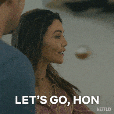 a woman says let 's go hon while looking at a man
