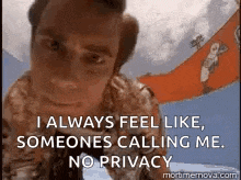 a man is standing in front of a sign that says i always feel like someone is calling me no privacy