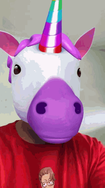 a man wearing a red shirt and a unicorn mask on his face