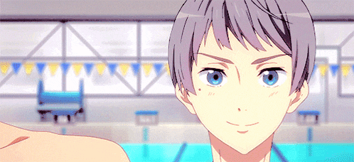 a boy with gray hair and blue eyes is standing in front of a pool .
