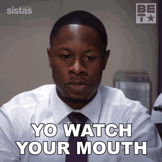 a man wearing a white shirt and purple tie says yo watch your mouth