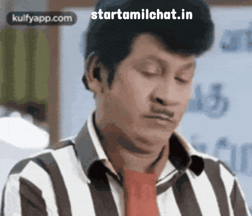 a man wearing a striped shirt and a red tie is making a funny face .