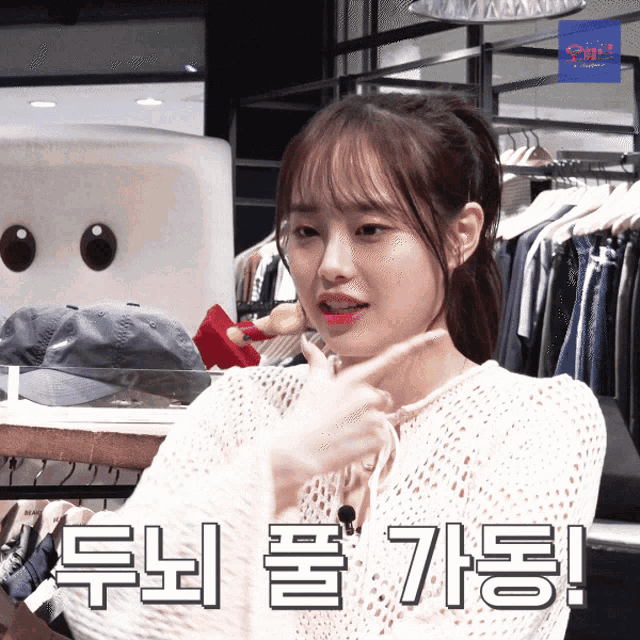 a girl in a white sweater with korean writing on the bottom