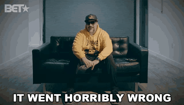 a man in a yellow hoodie sits on a couch with the words " it went horribly wrong " above him