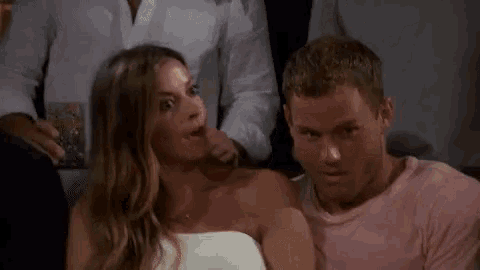 a man and a woman are sitting next to each other .