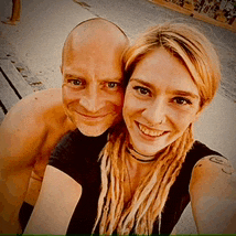 a man and woman are posing for a picture and smiling
