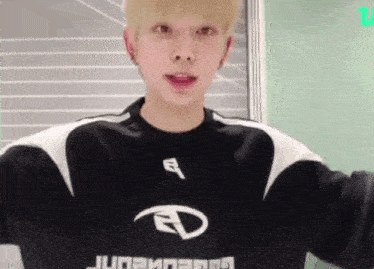 a young man wearing a black and white sweatshirt with the letter d on the front