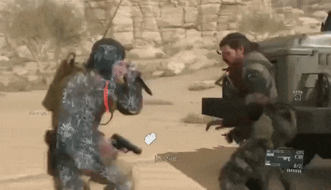 two soldiers are fighting in the desert in a video game . one of the soldiers is holding a gun .